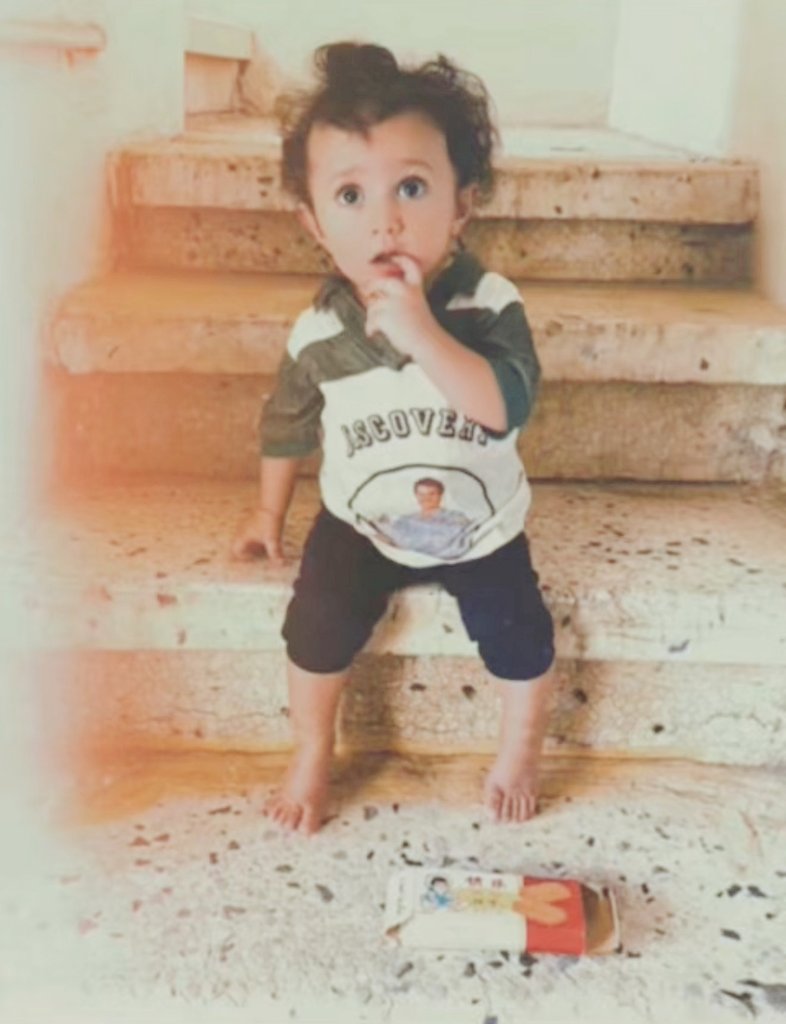 صورة طفل من جيل الثمانينات ميلادية  الصورة قبل ٤١ سنة 
الطقم اللي لابسة كان له مناسبة في وقته 
والبسكوت كان الأشهر في وقته
- من يعرف مناسبة الطقم
واسم البسكوت