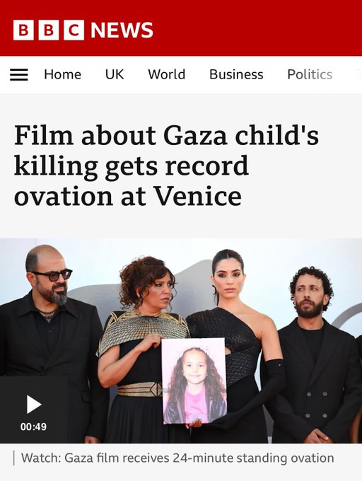 A group of four people standing together, holding a framed photo of a child identified as Hind Rajab. They are dressed in formal black attire, with one person wearing a shawl and another in a sleeveless dress. The BBC News logo and headline "Film about Gaza child\'s killing gets record ovation at Venice" are visible at the top of the image.