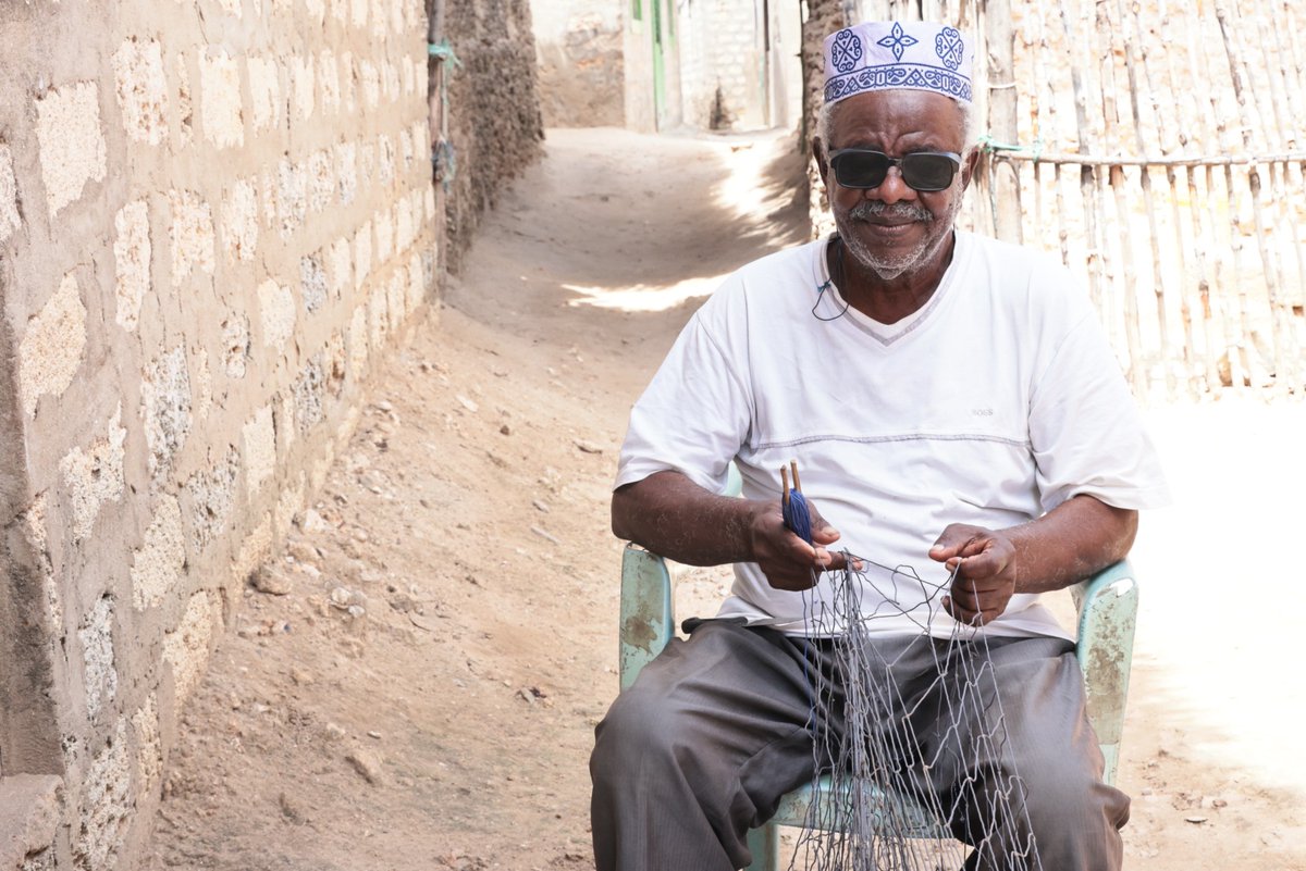 When fishers aren’t at sea, they repair their nets.
Meet Mzee Omar from Lamu — a veteran now repairs nets for young fishers.
With a KEMFSED grant, his community group got gear to fish deeper, keep catches fresh &amp; ease pressure on nearshore stocks. #Sustainablefisheries