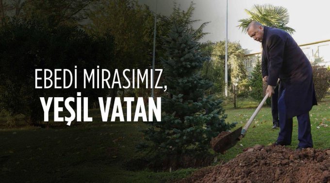 A person in a dark coat and blue pants digging into a mound of soil with a shovel. Evergreen trees and a palm tree are visible in the background. White text overlay reads "EBEDİ MİRASIMIZ, YEŞİL VATAN."