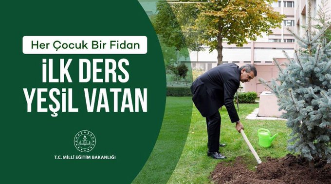 A man in a black suit planting a tree in a grassy area with a watering can. A blue evergreen tree and other greenery are visible. Text overlay reads "Her Çocuk Bir Fidan İlk Ders Yeşil Vatan" and includes a logo for T.C. Millî Eğitim Bakanlığı.