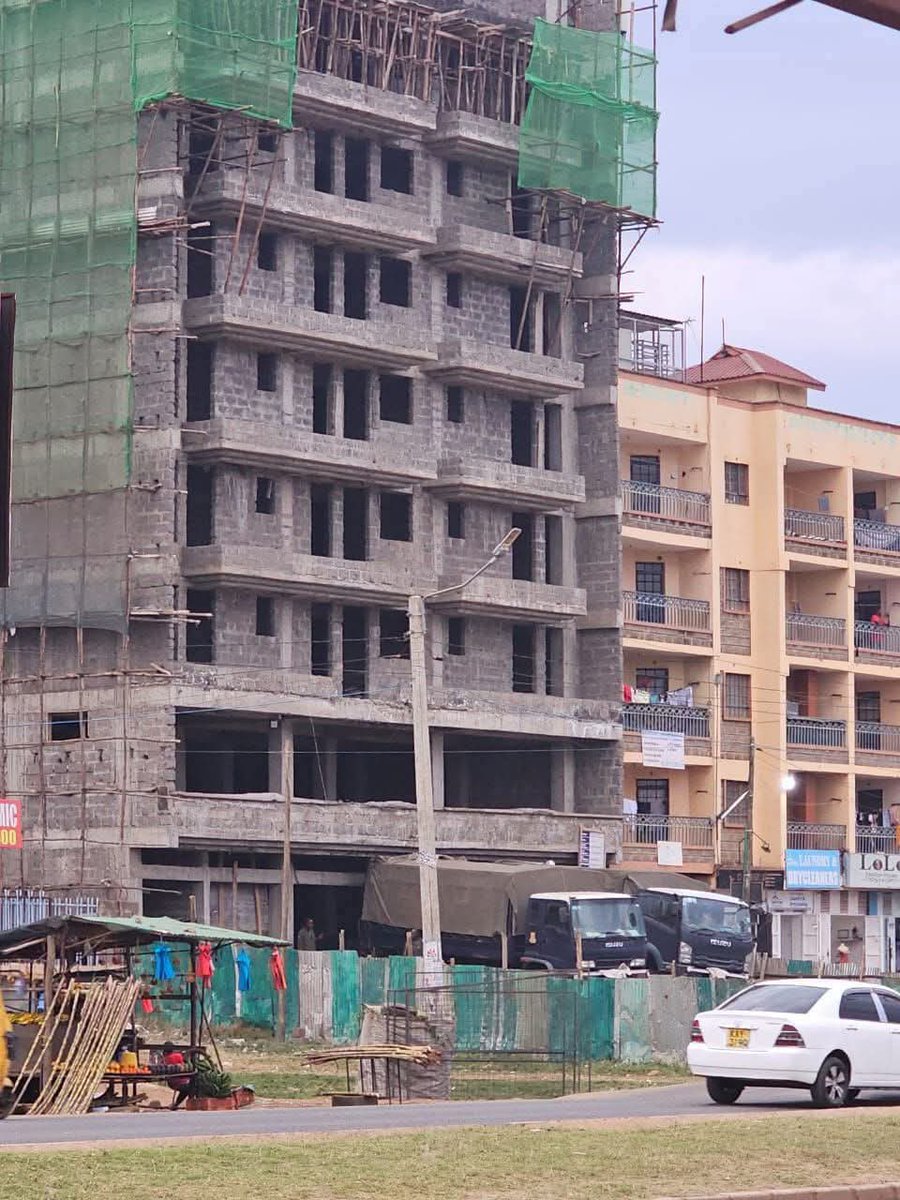 Yes it’s my building. Yes it’s under construction. Yes those are police trucks. No, they were not delivering materials. They only asked to park and I allowed them. Iko shida?