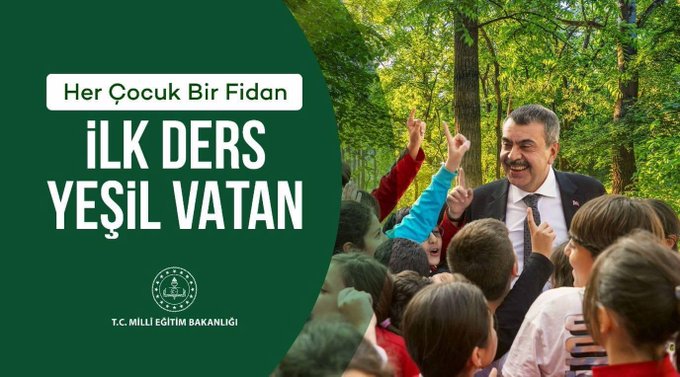 A group of children in casual clothing raising their hands, standing outdoors among trees. An adult man in a suit and tie stands with them, smiling. Green text overlay reads "Her Çocuk Bir Fidan İLK DERS YEŞİL VATAN" with a logo at the bottom left corner.