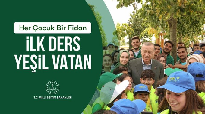 A group of children and adults wearing blue and yellow caps and green vests, standing outdoors among trees. An older man in a suit stands among them, smiling. Text overlay reads "Her Çocuk Bir Fidan İLK DERS YEŞİL VATAN" and includes a logo for T.C. Millî Eğitim Bakanlığı.