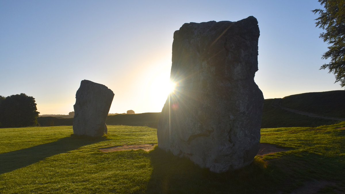 The morning sun rising above the henge bank at #Avebury.