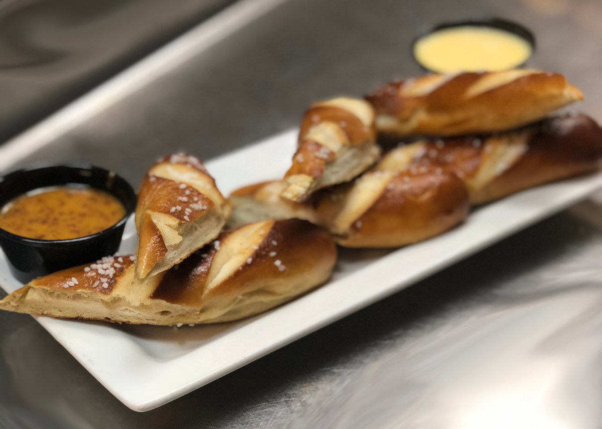 Ready for a delicious twist? 😋 Try our Bavarian Soft Pretzels, warm, soft, and salty, served with ale-spiked mustard! Perfect with any beer from our selection. 🍻 #SBCGoodEats #PretzelLove