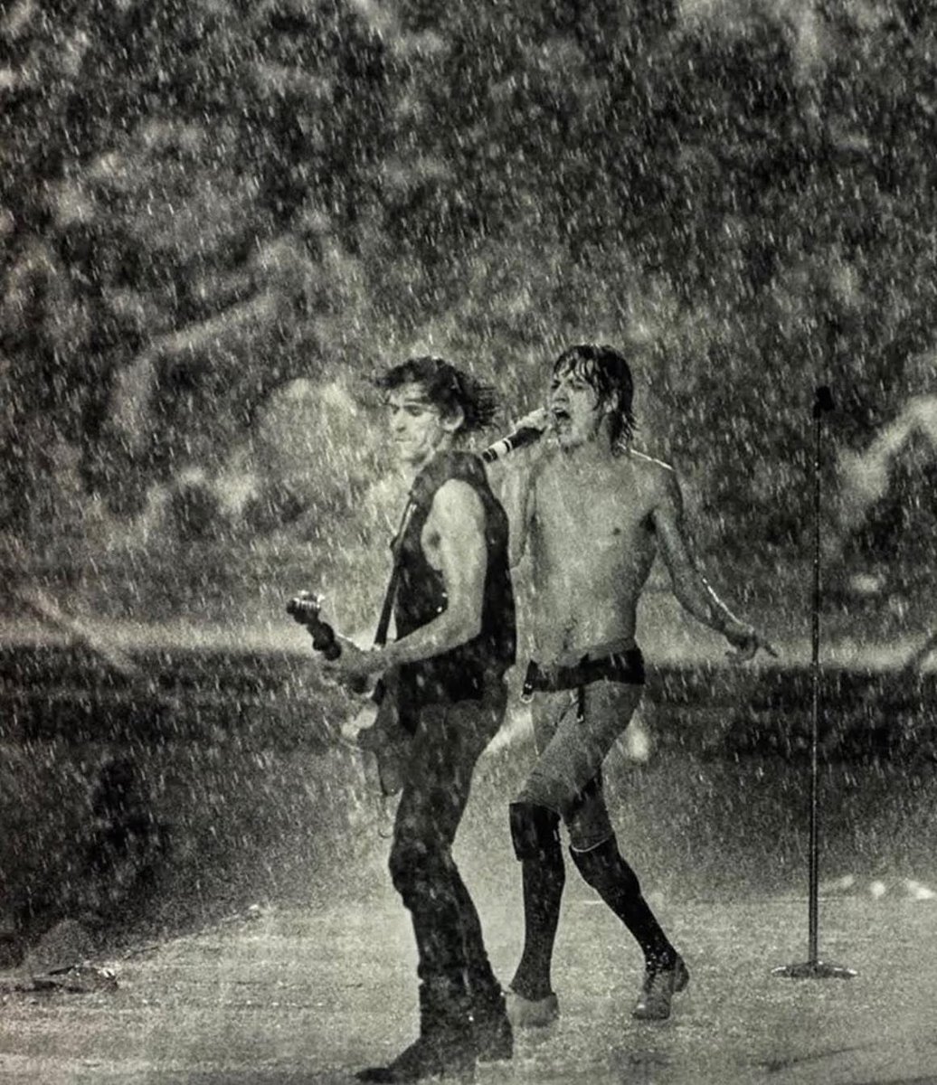 The Rolling Stones performing during a rainstorm at the Cotton Bowl. (1981)