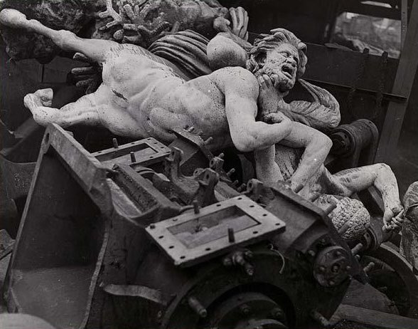 Pierre Jahan.

La Mort et les Statues.
1946.

Jahan published a book in collaboration with Jean Cocteau; ‘Death and the Statues’. 
Jahan had found a pile of statues in a Parisian breaker's yard ripped from their plinths by the Nazis to be melted down for their metal.

Symbolic.