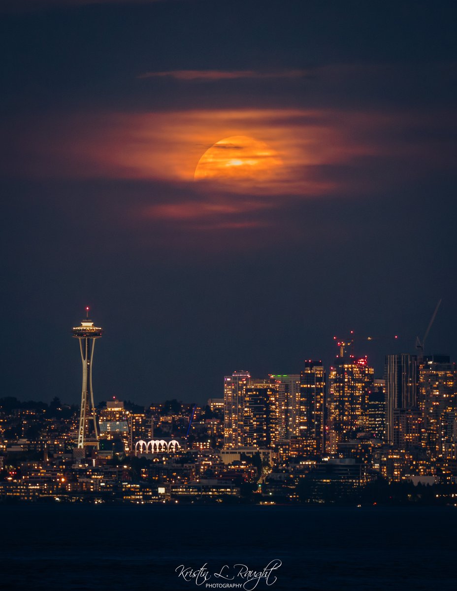 Moon poking out from behind the clouds after sunset tonight.