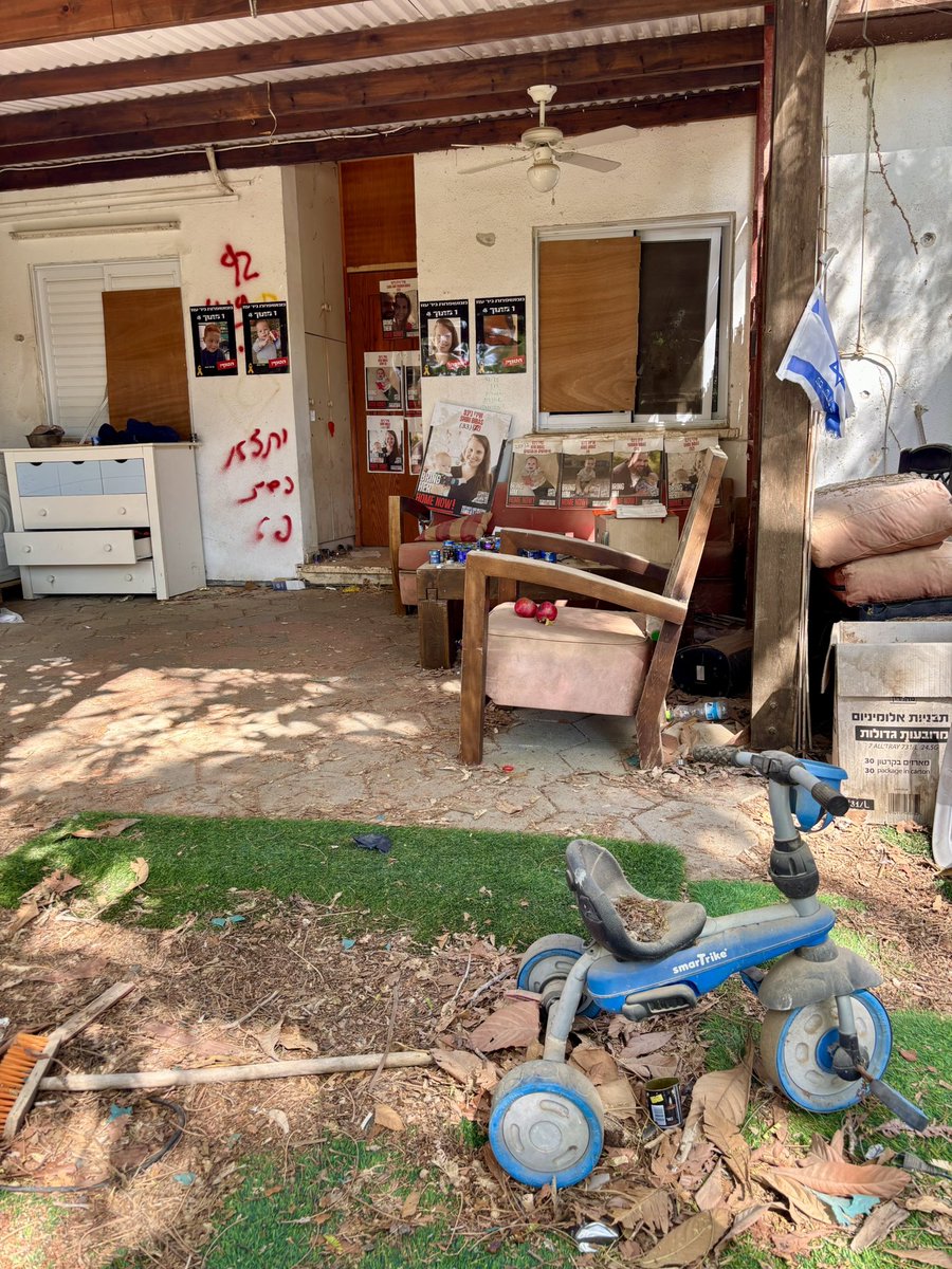 JuliaHB1's tweet photo. Today I visited the home of the Bibas family. On 7 October, Hamas terrorists stormed into the Nir Oz kibbutz close to the Gazan border. 

Out of a community of 400 people, 117 were murdered or kidnapped. All but 6 of the 220 houses were set on fire - mostly with families inside.

Among those kidnapped were Yarden and Shiri Bibas and their sons, Ariel, 4 and Kfir, 9 months old. Only the father, Yarden, survived. 

Ariel's tricycle still sits in the garden. 💔