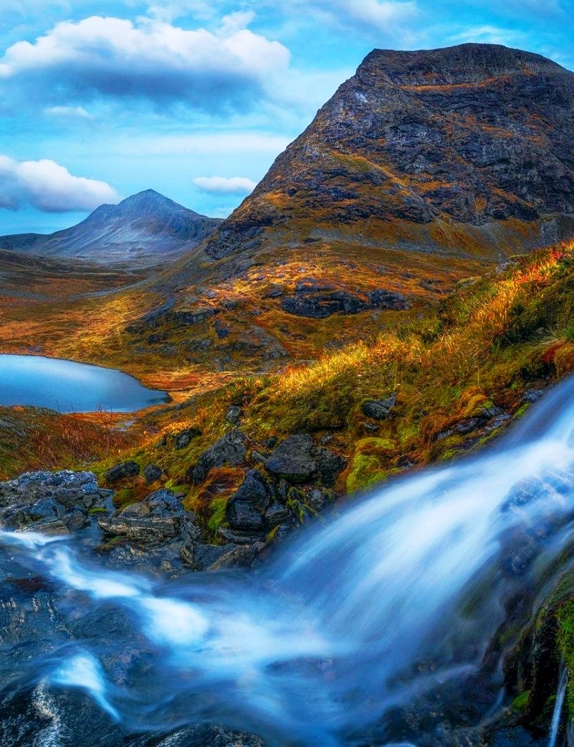 Romsdalen Valley and the Trolltindane mountains. In front view is one of the valley's many waterfalls, which all are flowing into Rauma River. This area is residing in the Møre og Romsdal county, Norway  🇳🇴