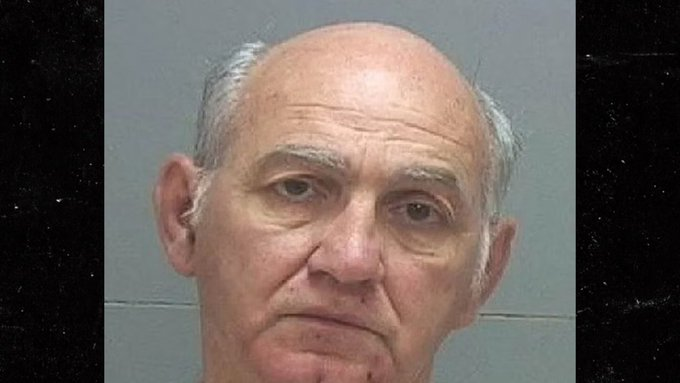 A mugshot of George Zinn, an older man with a bald head and gray hair on the sides, wearing a plain gray shirt, against a plain background.