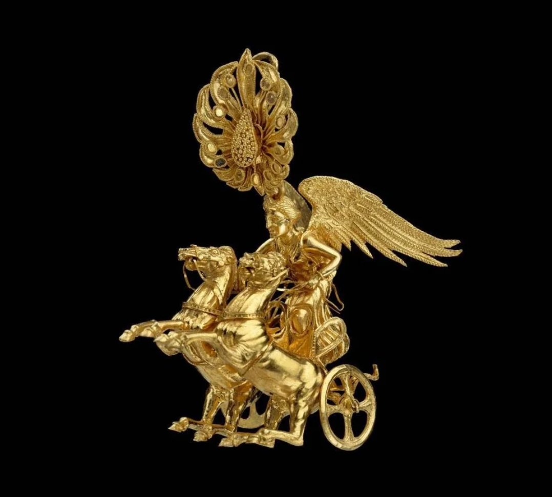 Ancient Greek gold earring featuring Nike, the goddess of victory, driving a two-horse chariot (a biga). This extraordinary earring dates back to Late Classical or Early Hellenistic Period, specifically around 350-325 BC, and was found in Peloponnese, Greece. It is a testament to