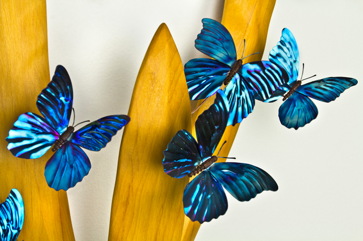 “Titanium Butterflies” by Casey Parlette showcases the delicate beauty of nature through sculpture.

Parlette draws inspiration from the fish, birds, and plants, transforming natural wonders into masterpieces, now at our Nature’s Palette Gallery.