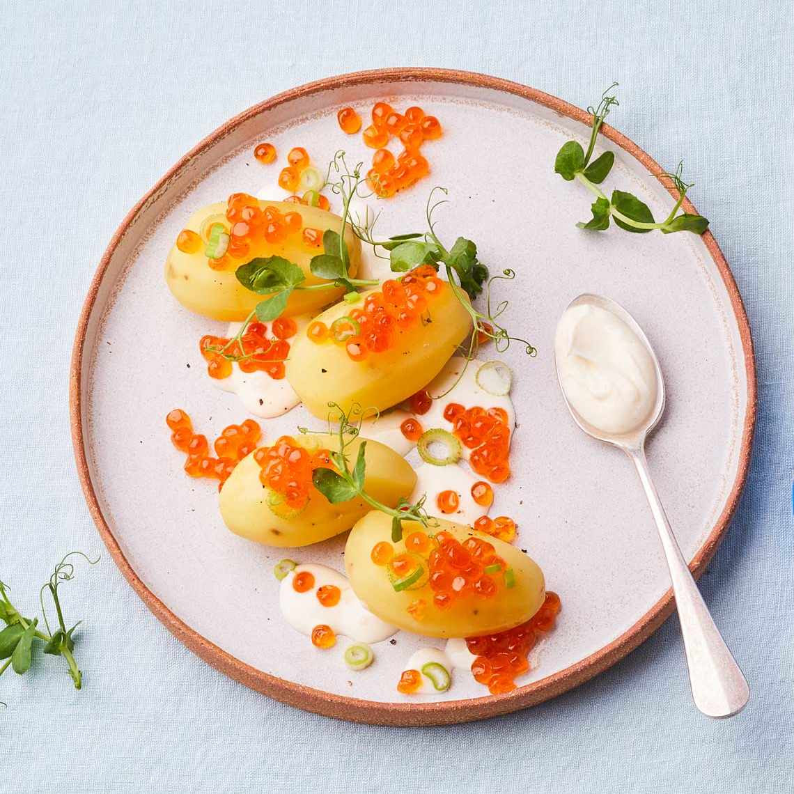 Our idea of a happy lunch (with almost no cooking): boiled Yukon gold potatoes, salmon caviar, and creme fraiche (or sour cream), plus pea shoots. From <a href="/PetrossianUS/">Petrossian</a>. The different types of caviar and roe: t.ly/S3Jy2.