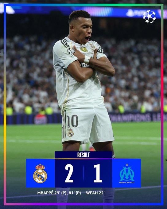 Kylian Mbappé wearing a white Real Madrid jersey with the number 10. He stands on a soccer field with arms crossed, celebrating. A crowd is visible in the background. Text overlays show a score of Real Madrid 2, Olympique de Marseille 1, and mentions Mbappé scoring twice.