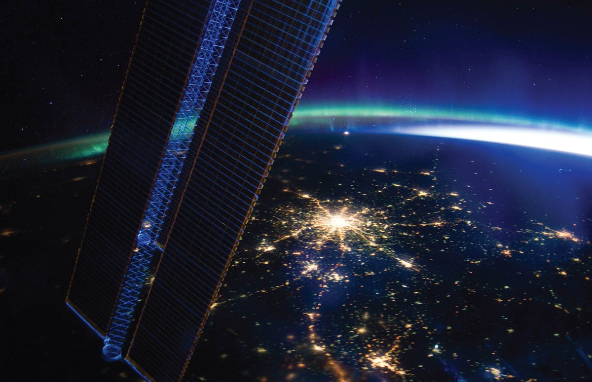 This breathtaking nighttime view of Moscow was photographed by the Expedition 30 crew aboard the International Space Station. The ISS solar array panel is visible on the left, while daylight emerges from the right. The vibrant green glow is the aurora borealis.