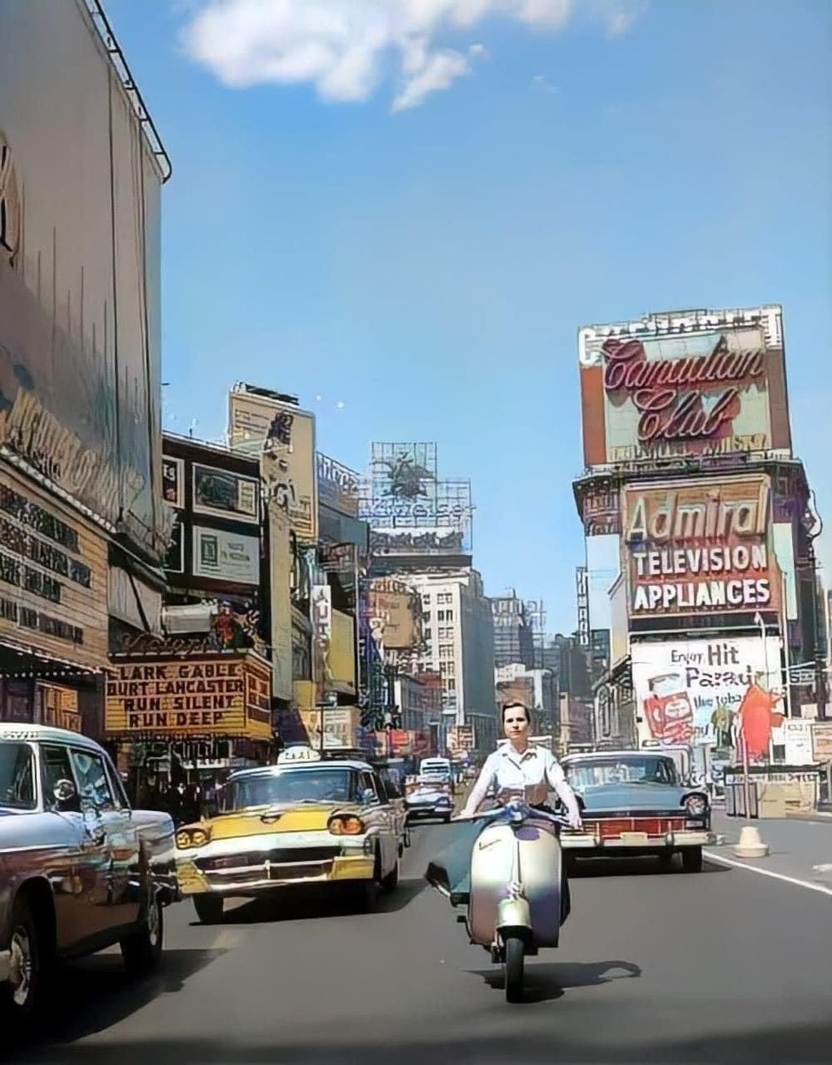 Woman riding a Vespa in Times Square, NY, 1958.