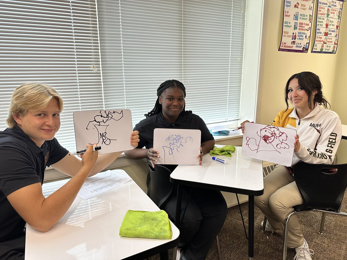 Spanish 3 students are doing an activity called “artistas ciegos” or blind artists. A group member describes a “painting” in Spanish (using environment vocab) and other members try to draw the painting without looking!