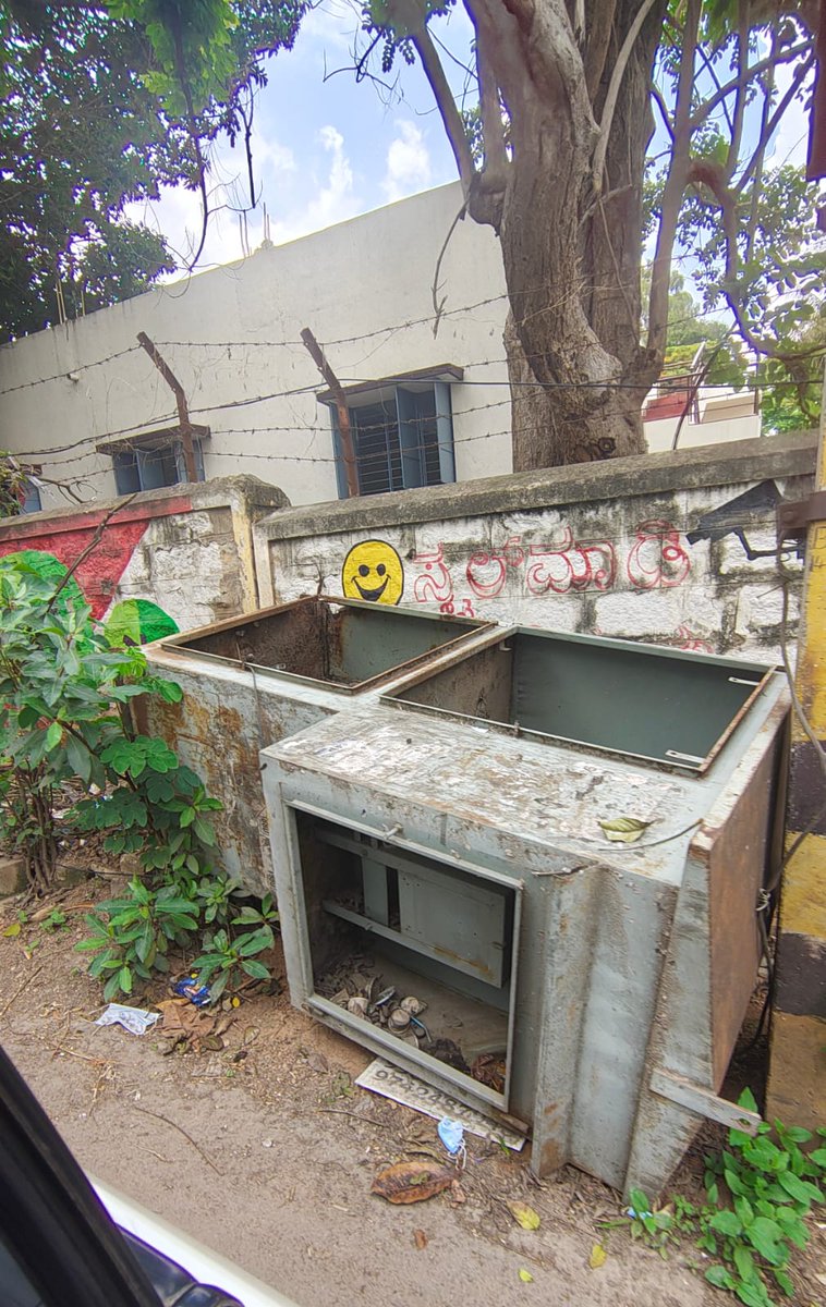 Poori5678's tweet photo. Why is it so difficult for @BESCOM to clear a defunct transformer box that’s slipping onto the only entry/exit road of an 800+ household community? This rusting hazard endangers every pedestrian &amp; driver passing by. Must we wait for a mishap before action is taken? #Bangalore https://t.co/FnjeXlSWOm