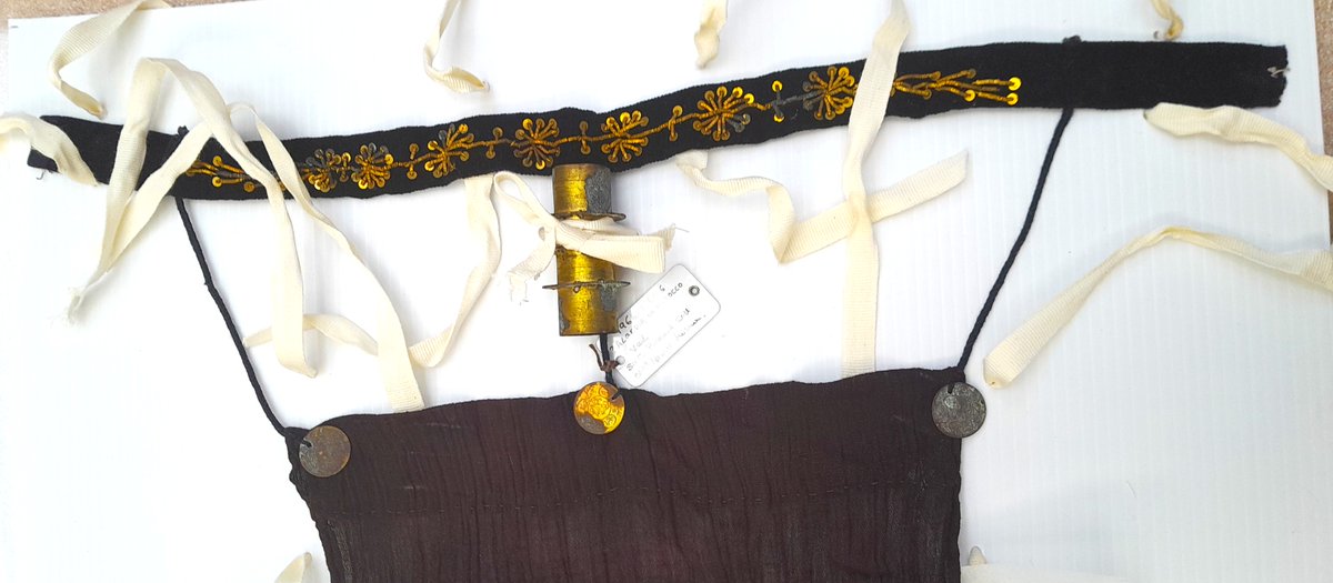 ConservationBob's tweet image. Ipswich Museum conservation.  Cleaning of a 19th century Moroccan woman's veil. Yellow metal coins decoration and braid sewn to cloth and velvet. Textile shielded with strips of Melinex whilst metal chemically cleaned washed and treated with microcrystalline wax.