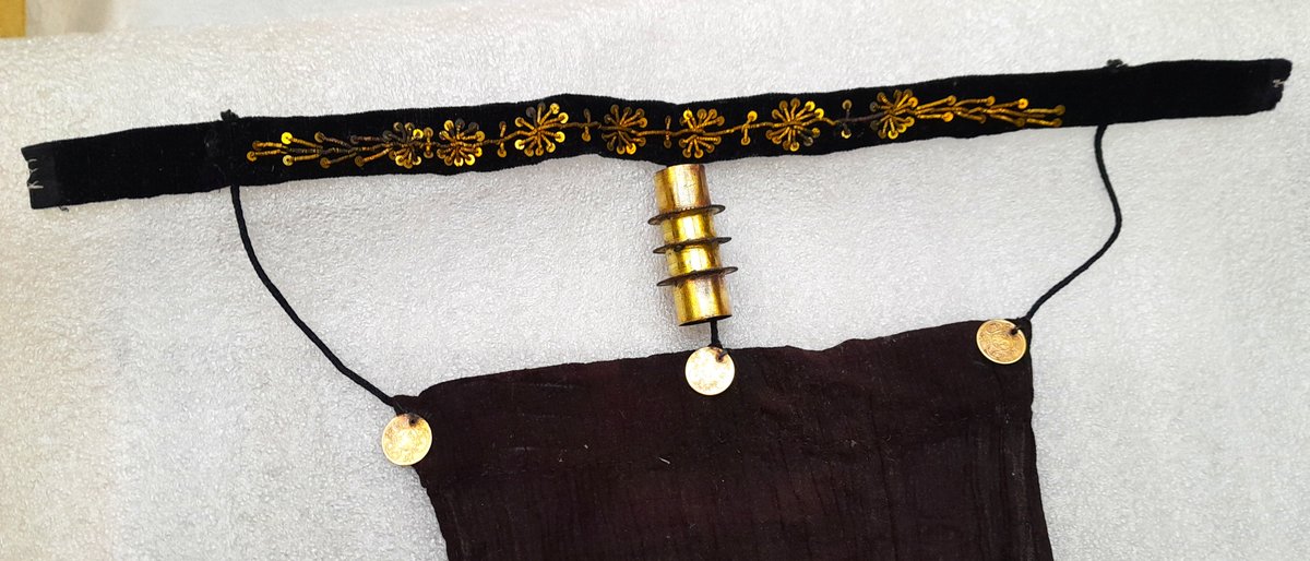 ConservationBob's tweet image. Ipswich Museum conservation.  Cleaning of a 19th century Moroccan woman's veil. Yellow metal coins decoration and braid sewn to cloth and velvet. Textile shielded with strips of Melinex whilst metal chemically cleaned washed and treated with microcrystalline wax.