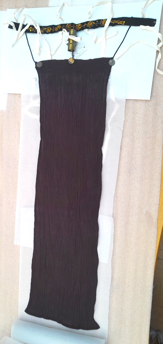 ConservationBob's tweet image. Ipswich Museum conservation.  Cleaning of a 19th century Moroccan woman's veil. Yellow metal coins decoration and braid sewn to cloth and velvet. Textile shielded with strips of Melinex whilst metal chemically cleaned washed and treated with microcrystalline wax.