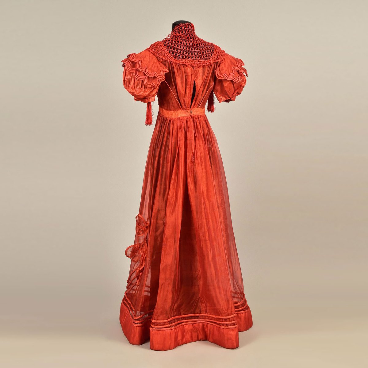 Fashion in 1828: Cinnabar Silk &amp; Striking Style 📷
This cinnabar silk gauze gown dates to 1828, with its wide puffed sleeves, satin rouleaux trim, and airy bows at the skirt hem. A macramé silk tippet is finished with tassels.
Whitaker Auction