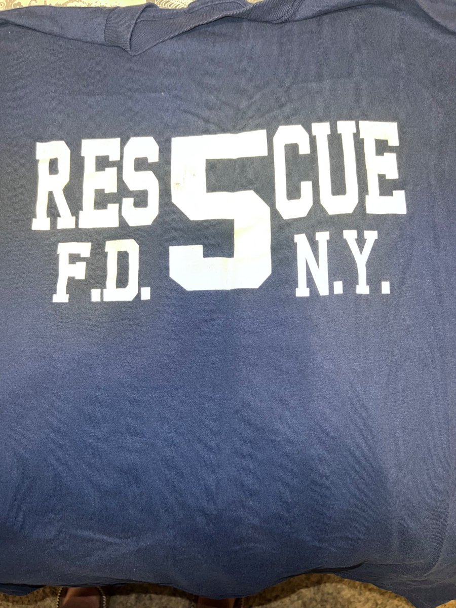 BaltCoFire's tweet photo. A Super Bowl XXXV bet. A Ravens win. FDNY Rescue 5 sent their shirt to #BCoFD Towson Fire Station. Months later, 9/11 took most of those firefighters. This shirt now symbolizes unity, courage &amp; sacrifice. #NeverForget #FDNY https://t.co/GXPK7HQk1T