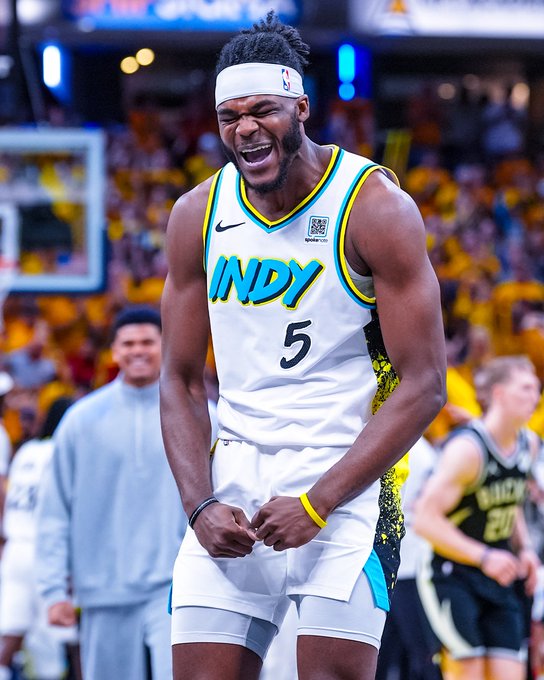 Walker wearing a white Indiana Pacers jersey with the number 5 and "INDY" text. He has a headband, wristbands, and is on a basketball court with a crowd in the background. Other players in jerseys are visible.