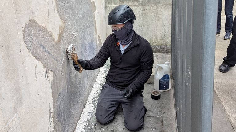 DFinsterwalder's tweet image. The removal was done SO BAD that I think it could be Bansky himself. The stone is sandstone which is super porous. It looked like that masked guy rather rubbed it IN using solvents (1st photo) instead of using special vacuums that suck the color out of sandstone (2nd photo).