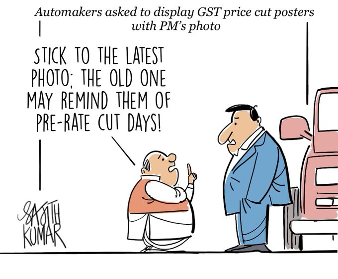 Two cartoon characters, one wearing a suit and the other in a vest, stand near a pink car. The suited character gestures toward the car while the vested character points upward. Text overlays include "Automakers asked to display GST price cut posters with PM\'s photo" and "STICK TO THE LATEST PHOTO; THE OLD ONE MAY REMIND THEM OF PRE-RATE CUT DAYS!" A signature "Sajith" is visible.