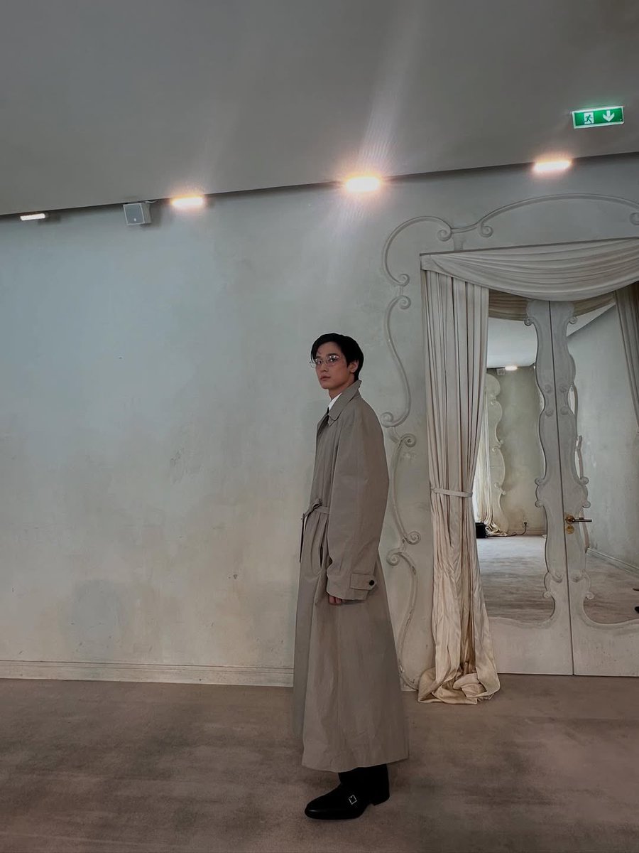 Wrapped in an elegant trench, a profile of poise and subtle power. Every detail curated, every glance profound.