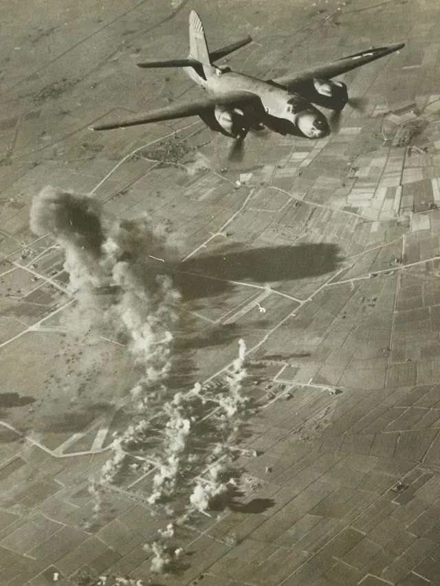 March 1944: Smoke rises from the Luftwaffe airdrome at Leeuwarden, Holland, during a dramatic attack by American B-26 Marauder bombers. 
The attack caused significant damage to the airfields buildings and flak bunkers, that are just visible below.

#wwii #planespotters #aviation