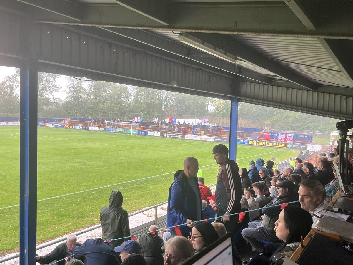 #YCFC fans at Braintree. Quite a few have been allowed into the covered home end with thunder and lightning here too.