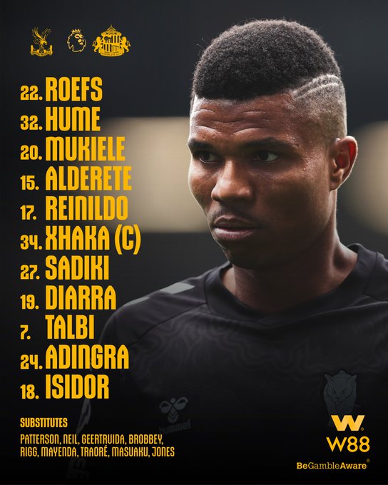A man with short, dark hair and a sharp hairline design, wearing a black sports jersey. Text overlay lists player names and numbers: 22. Roefs, 30. Hume, 20. Mukiiele, 15. Alese, 17. Reniildo, 14. Neil, 34. Xhaka (C), 27. Sadiki, 19. Diarra, 18. Talbi, 7. Adingra, 24. Isidor. Substitutes include Patterson, Neil, Geertruida, and others. Watermark "W88" and "BeGambleAware" logos are visible.