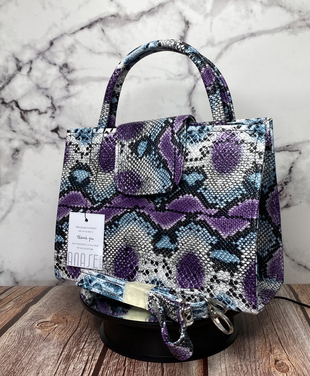 Anase_ng's tweet image. Heritage 001
The IFE bag.
NGN 18,000
Statement top-handle in a bold purple/blue python print with a detachable crossbody strap. 
Chic, compact and perfect for brunch, weddings, and everyday polish.