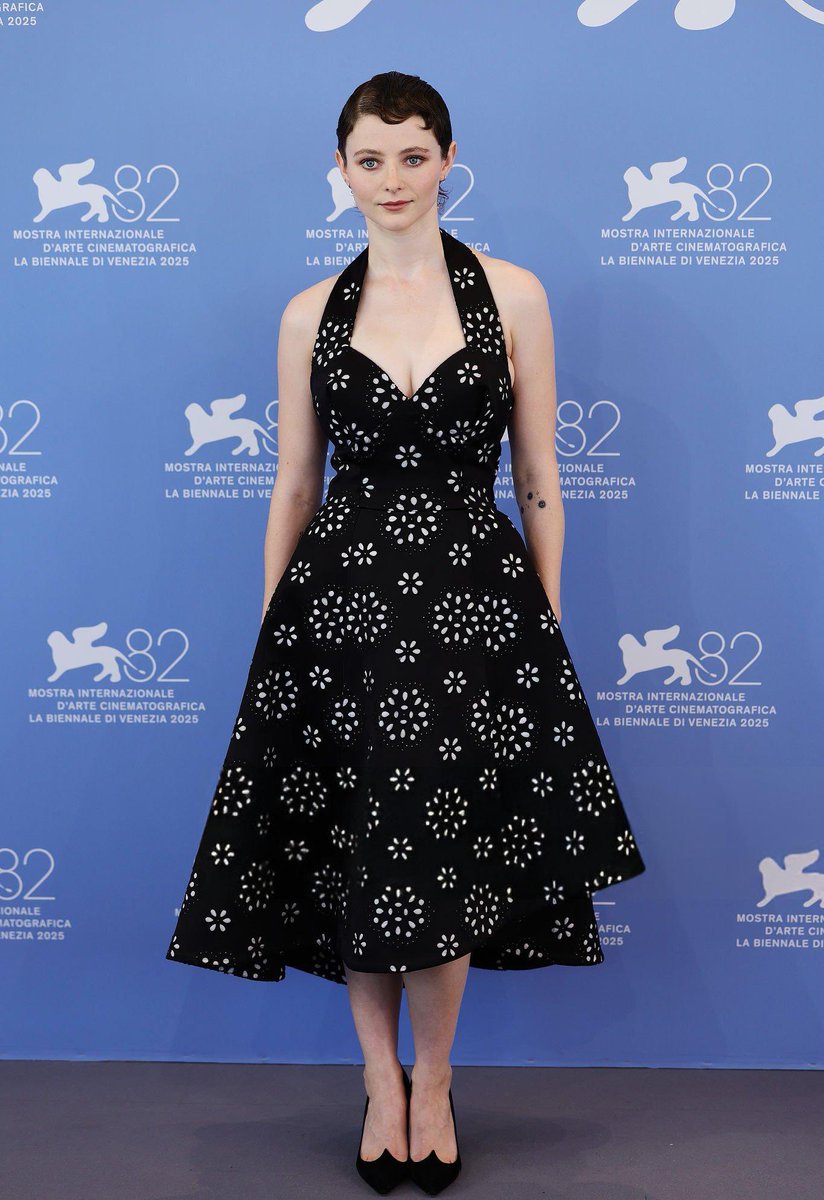 Thomasin McKenzie, styled by Leith Clark, wears a black eyelet-embroidered halter dress from the Marc Jacobs Fall 2025 collection to The Testament of Ann Lee photocall during the 82nd Venice International Film Festival
