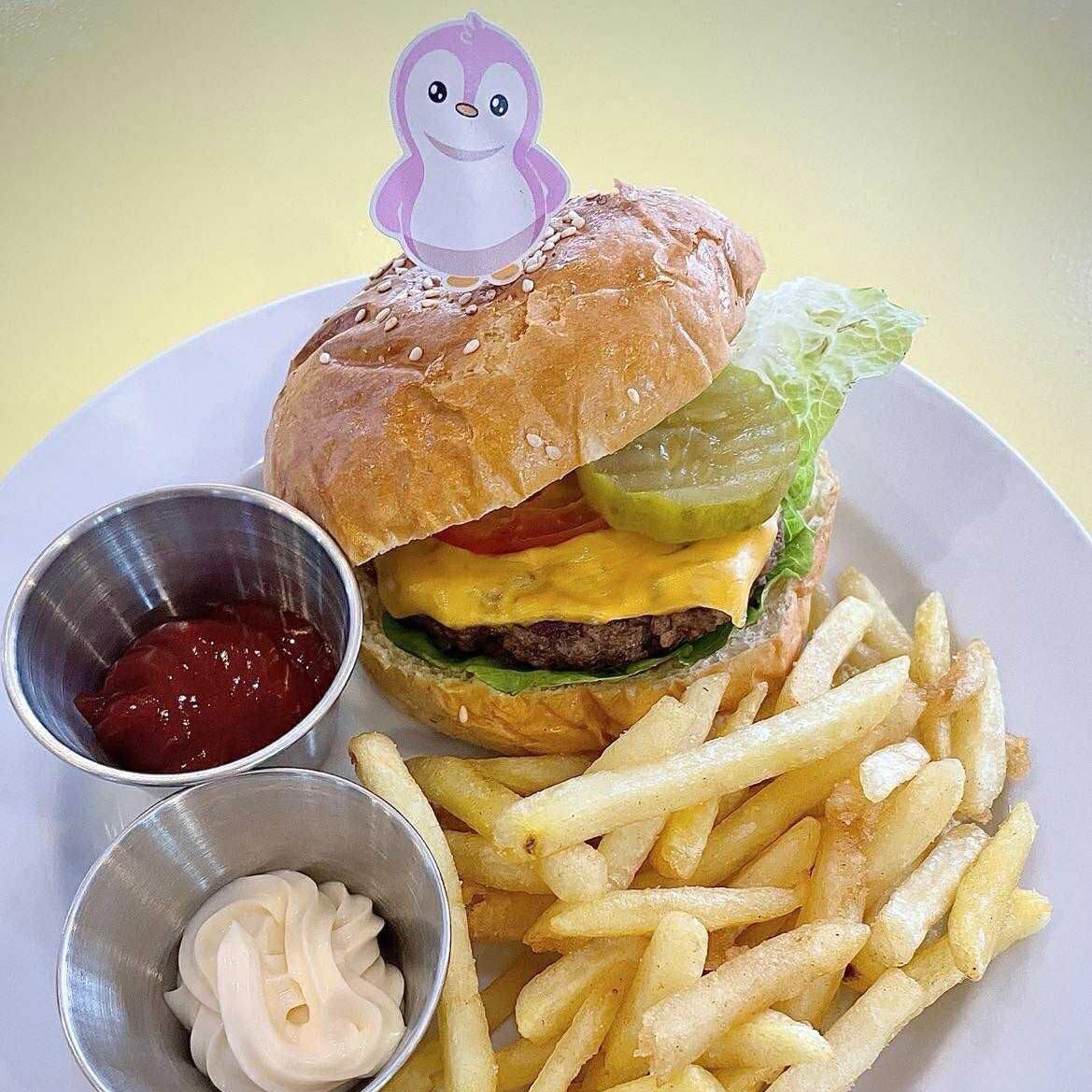 A juicy, grilled beef patty layered with melted cheese, fresh crisp lettuce, ripe tomatoes, caramalized onion and tangy pickles, all tucked inside a soft, toasted bun. Every bite delivers the perfect balance of savory, cheesy, and satisfying flavors.

Try it @ <a href="/PenguinsCafe_/">Penguins Café</a> 🐧☕️