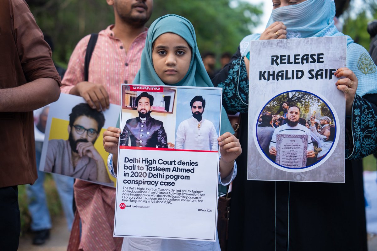 A photo of Tasleem Ahmed’s daughter holding a <a href="/MaktoobMedia/">Maktoob</a> poster, which reads that the Delhi High Court dismissed her father’s bail plea on the very day he completed 1,902 days in jail under the draconian UAPA, is heartbreaking. 

At one of India’s most prominent university