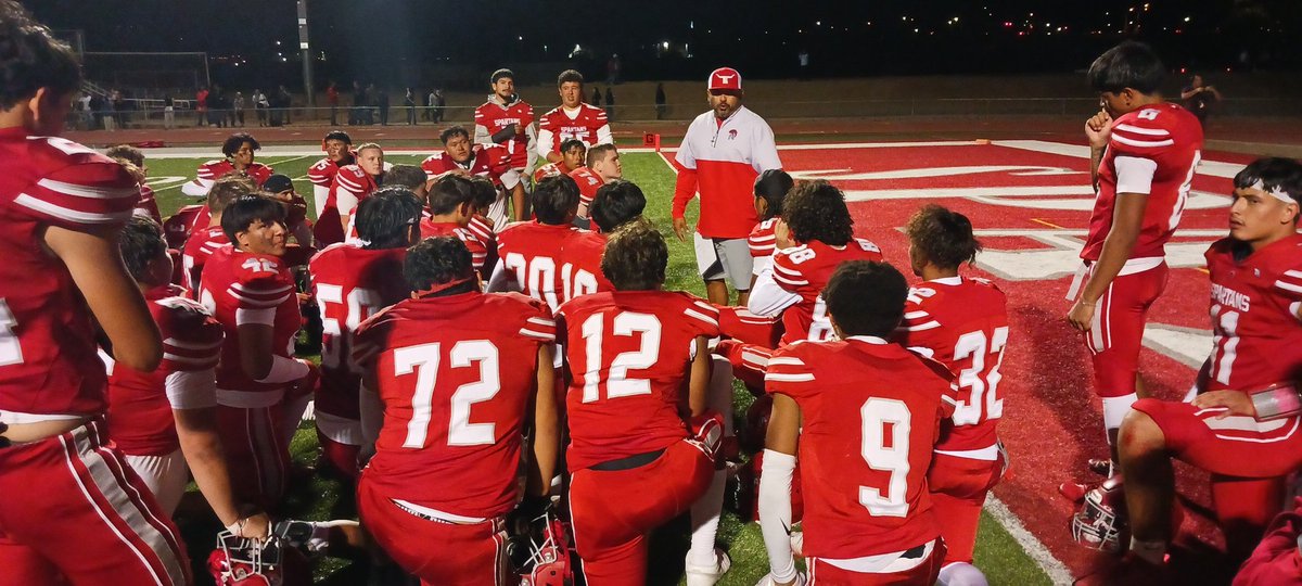 Bernalillo head coach John Cobos talks to his team following the 41-12 win over Espanola Valley.