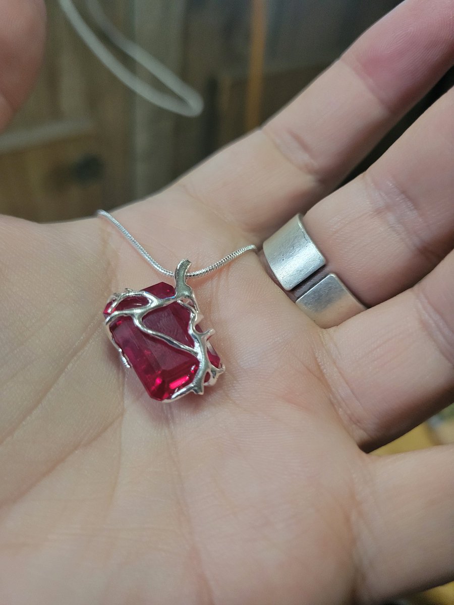 A lab grown ruby wrapped in 925 stealing silver and a 925 stealing silver chain, ask me for the price