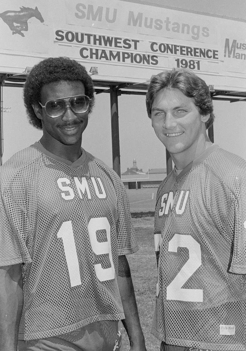 Eric Dickerson and Craig James standing in front of a SWC Champions billboard (1981)