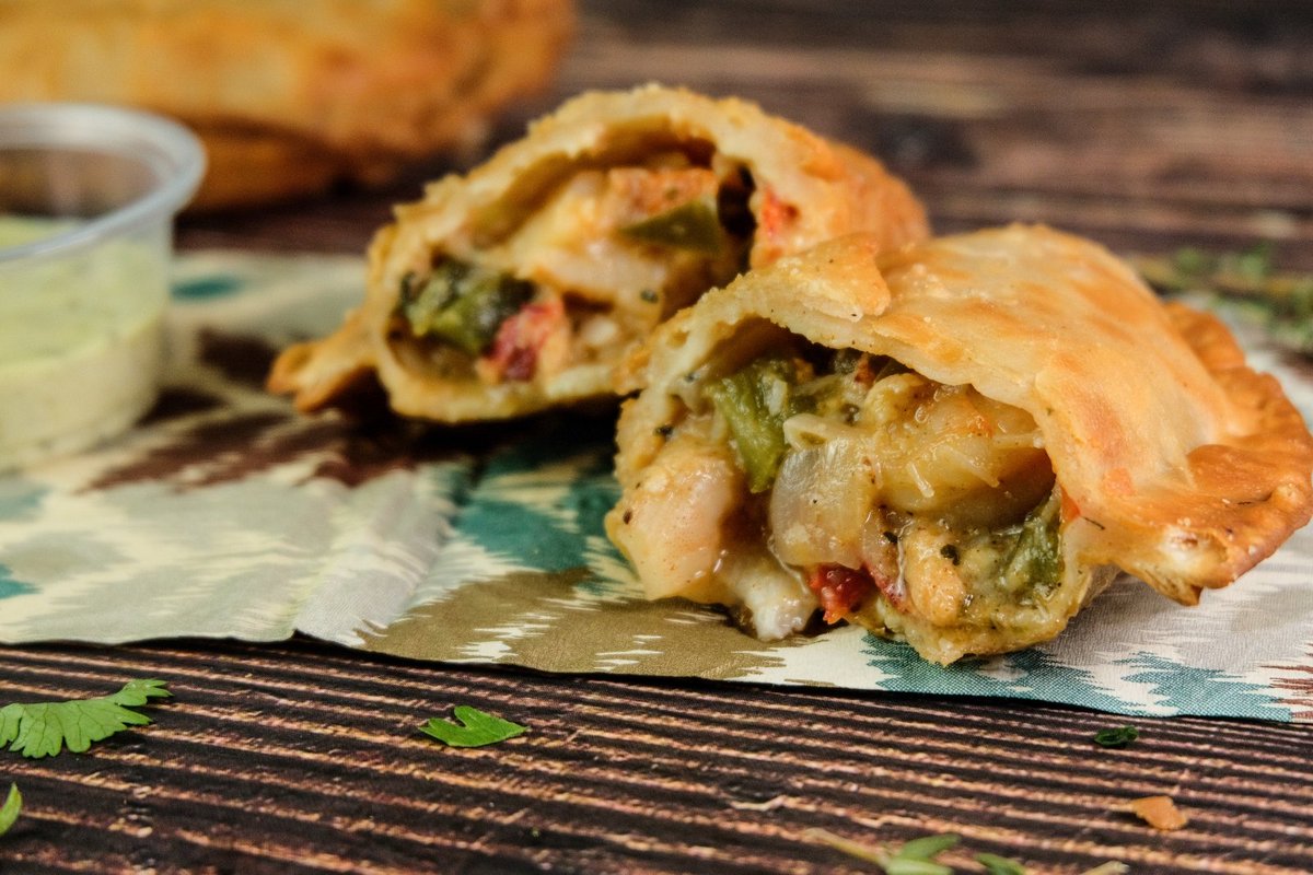 Get ready, foodies! 🍽️ Our Lobster &amp; Shrimp Empanada is making taste buds dance all over town. Filled with lobster, shrimp, and a splash of Creole magic - it's a fan favorite for a reason! 😋 #SpiceTheAmericas #SeafoodLovers #FoodieFavourite