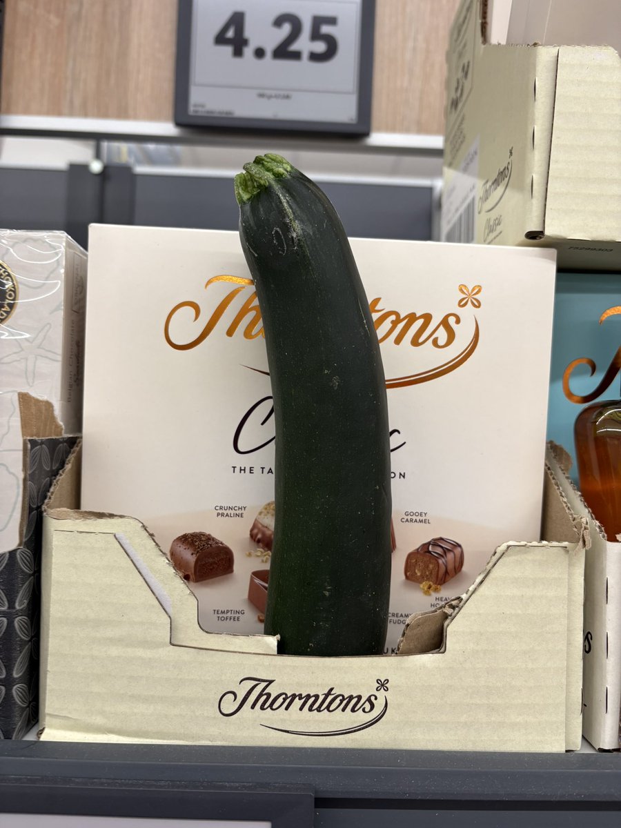 NotThatAlan's tweet image. Spotted in Lidl. Box of Thorntons and a  and a cucumber, nothing says “date night” like that.