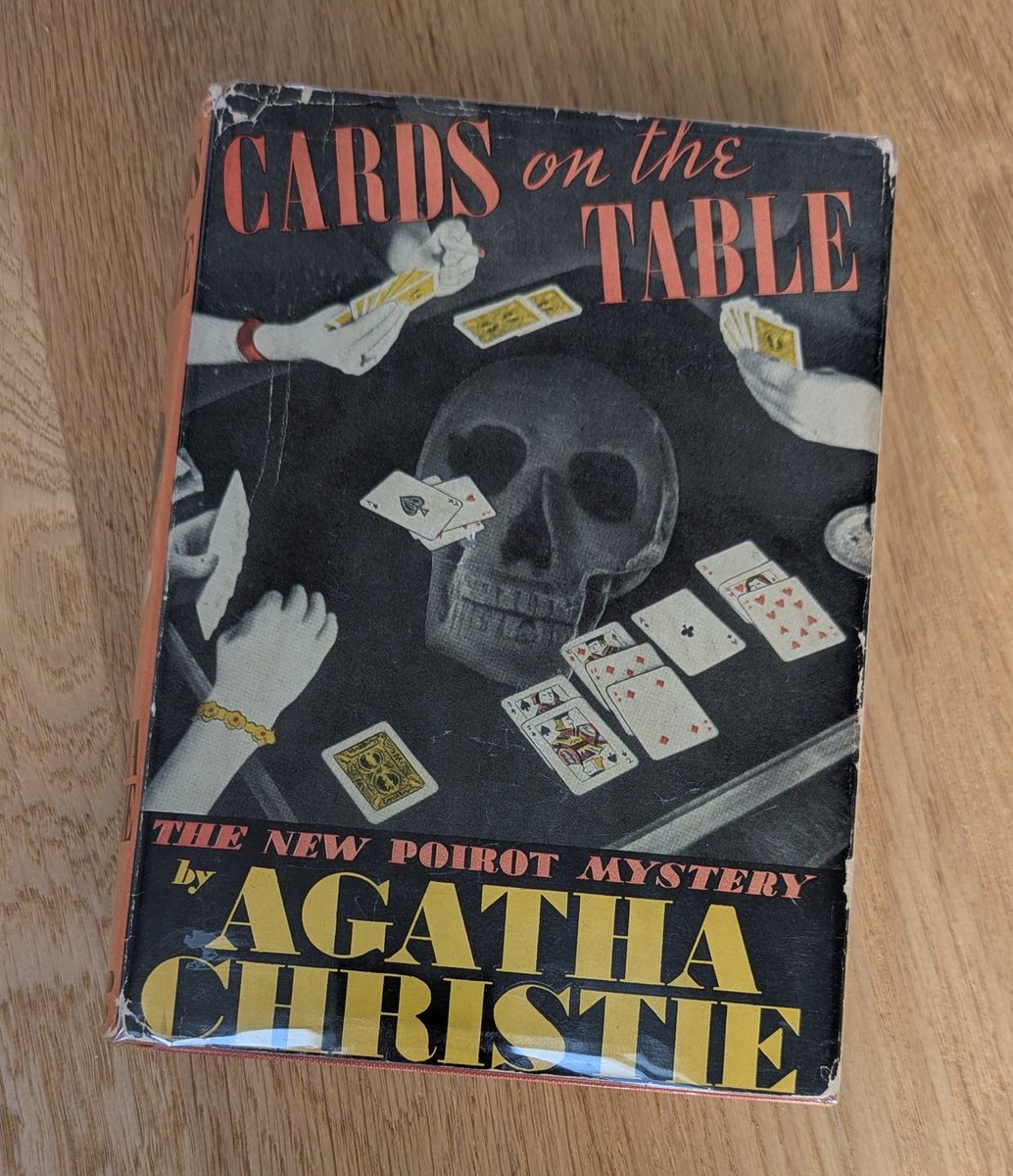 CollectChristie's tweet image. Cards on the Table - #agathachristie - 1st American edition (Feb 1937). Book quote: "Every murderer is probably somebody's old friend" - #poirot  A unique dust wrapper with the skull apparition. #firstedition #rarebooks #crimefiction &amp;amp; yes, I photographed the book on the table!