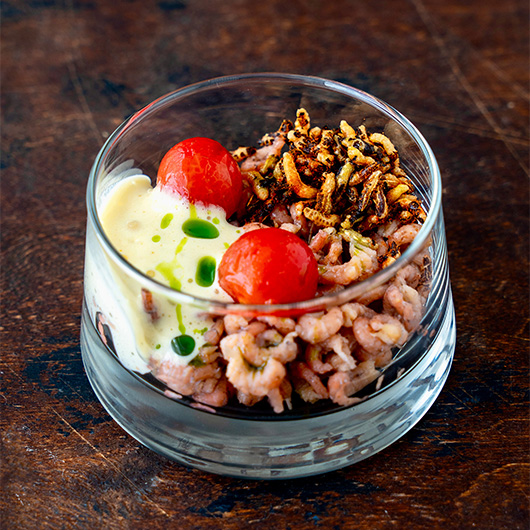 Layers of flavor in a glass 🌿🦐🧀 Briny North Sea shrimp, airy cheese foam, pickled sweet tomatoes, crunchy puffed wild rice, and a hint of basil oil. Small bite, big wow! ✨ bit.ly/4nsyWaS #RecipeOfTheDay