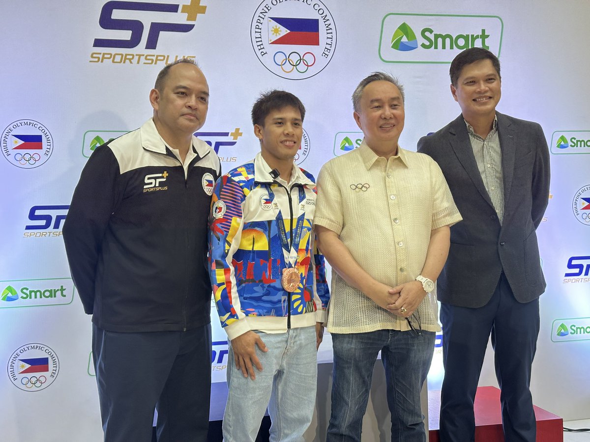Mr. James Da Costa (Sportsplus Head of Partnership) Carlos Baylon Jr. (Wushu Sanda 2025 bronze), POC President Hon. Bambol Tolentino, and Mr. Jude Turcuato (PLDT-Smart Head of Sports) at the MOA signing between POC and Sportsplus, with the support Smart, connectivity partner.