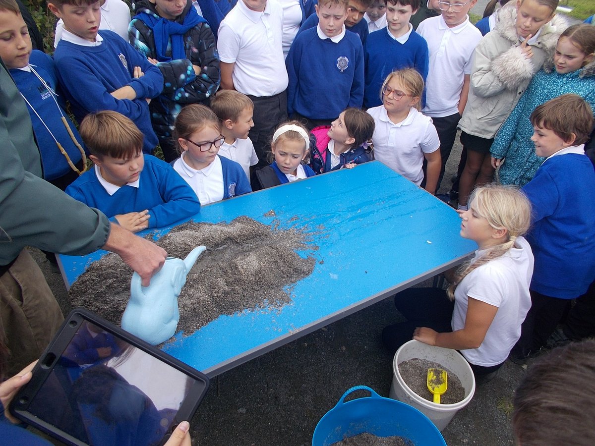 Year 5 and 6 have taken their learning outside to our Outdoor Education Area to learn about how river deltas form with water, sand and growan in a practical session.