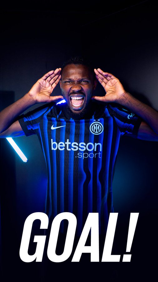 A man wearing an Inter Milan jersey with blue and black vertical stripes, featuring the "betssson" logo. He has his hands raised to his head, smiling widely. The word "GOAL!" is overlaid in large white text at the bottom.